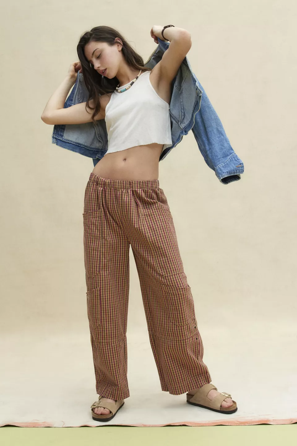 A woman wearing brown gingham pants