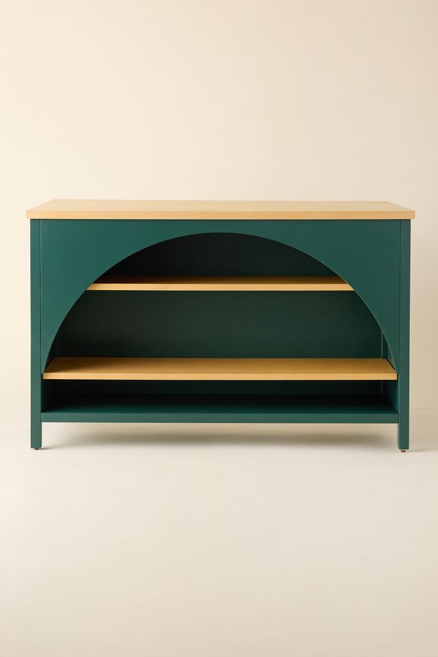 Teal kitchen island/base with open shelves and curved arch cutout