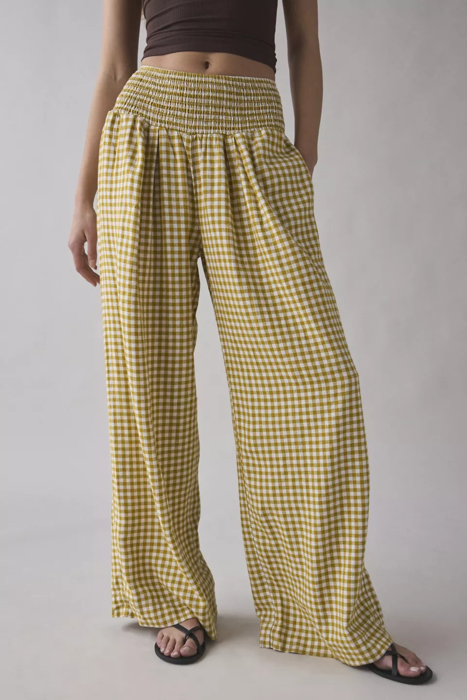 A woman wearing yellow and white checkered pants